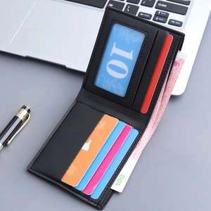 Classic black leather bi-fold wallet for men with card slots on office desk background