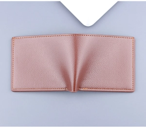Close-up of brown leather bifold wallet featuring lychee texture and neat stitching