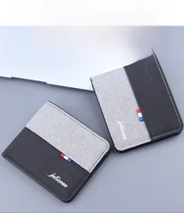Close-up of contrast-color canvas bi-fold wallet featuring a logo and tricolor ribbon label