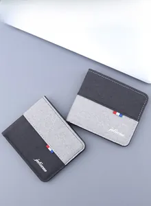 Detail of bi-fold canvas wallets with gray fabric textures and contrast stitching