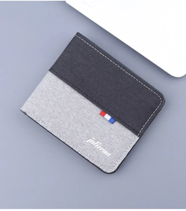 Close-up of canvas bi-fold wallet with contrast stitching and color block design