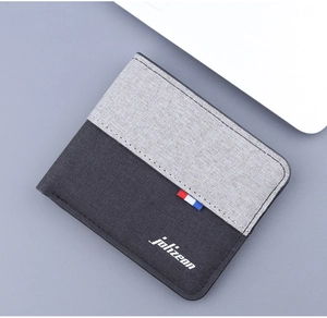 Detail of bifold canvas wallet with gray color blocking and striped ribbon trim