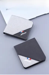 Detailed shot of men's canvas wallets with grey and black patchwork and striped ribbon