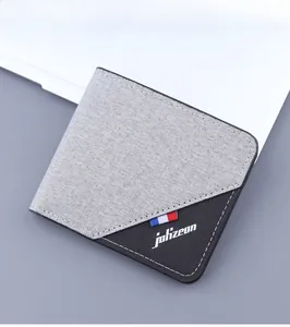 Close-up of grey canvas bifold wallet featuring tri-color stripe detail and logo