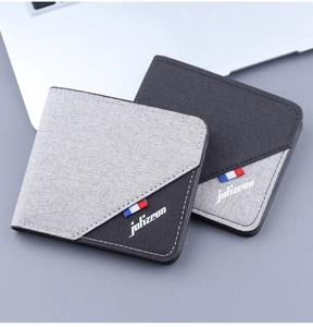 Macro detail of high-density canvas wallets featuring contrast stitching and brand logo