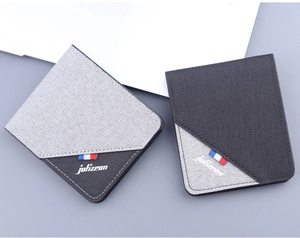 Detailed view of men's canvas wallet showing grey textured fabric and color-block design