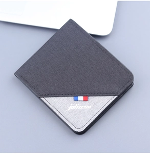 Detail shot of men's bifold canvas wallet with bicolor grey panels and logo branding