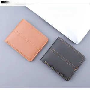 Close-up of brown and dark grey soft leather men's wallets with refined stitching detail