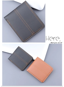 Detail of short leather wallet with litchi grain and orange contrast stitching