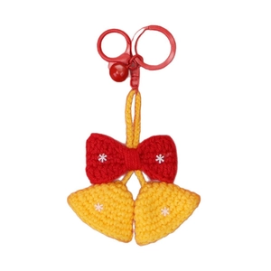 Handmade crochet Christmas pendant featuring festive red bow and bells on white background