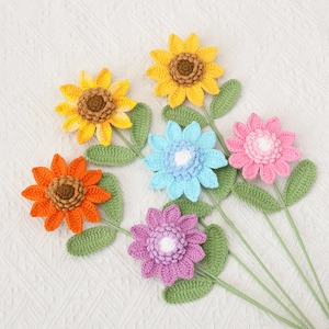 Macro shot of six handcrafted crochet sunflowers and daisies in vibrant mixed colors