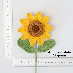 Macro detail of hand-knitted sunflower showing its 10-15cm size next to scales