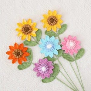 Detailed view of hand-knitted crochet sunflower and daisy bouquets with soft cotton texture