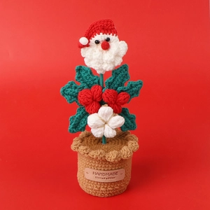 Close-up of handmade crochet Santa Claus potted plant with premium leather label detail