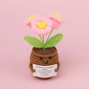 Handmade crochet lily of the valley potted plant with pink flowers and smiley face pot