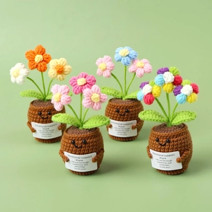 Handmade crochet emotional support potted plants with inspirational cards on green background