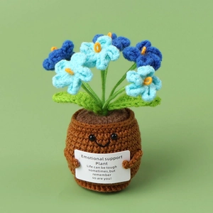 Close-up of handmade crochet blue flower plant with an inspirational support card