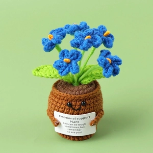 Close-up of blue crochet puff flower in a smiling pot with a small white gift card