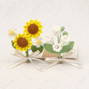 Handmade crochet sunflower and lily of the valley bouquet with a gold-edged white ribbon bow