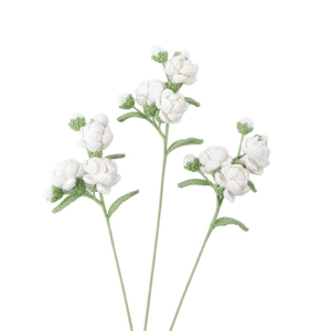 Three handmade crochet white jasmine flowers with green stems on a clean white background