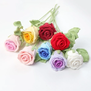 Detailed view of colorful handmade crochet rose bouquets in pink, yellow, and blue shades