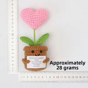Handmade crochet heart potted plant display with ruler showing 14cm height and 28g weight
