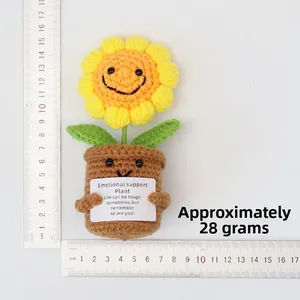 Detailed view of handmade crochet sunflower pot with size ruler and motivational card