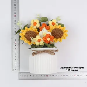 Detail view of handmade knitted sunflower pot with scale showing 15cm height and 115g weight