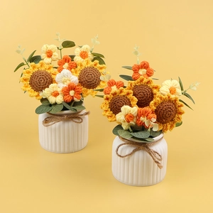 Handmade crochet sunflower potted plants in white ceramic vases with a rustic twine bow