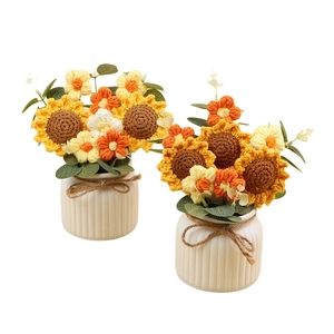 Handmade knitted sunflower potted plants with white ceramic vases and jute bows