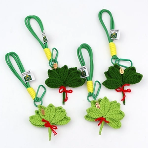 Detail of handmade woven pomelo leaf charms with auspicious gold tags and green clips
