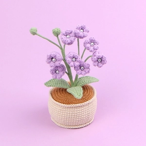Handmade crochet lily of the valley potted plant with purple flowers and pearl accents