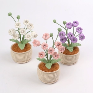 Close-up of handmade crochet lily of the valley potted plants with pearl details