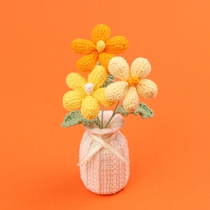 Handmade crochet flower vase ornament featuring yellow and orange knitted frangipani blossoms
