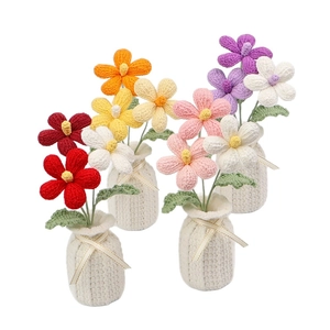 Handmade crochet plumeria flowers in knitted mini vases for home desktop decoration