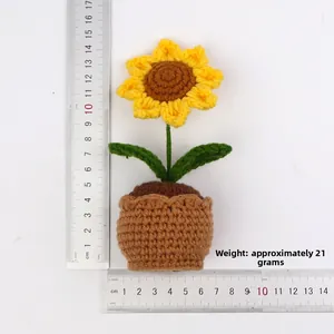 Handmade crochet sunflower potted plant in vibrant yellow with measurement scale display