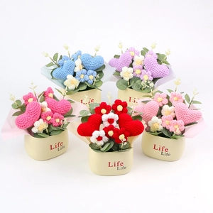 Detailed view of handmade crochet potted flowers with hearts and knitted texture
