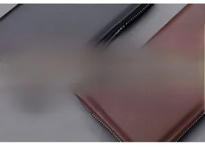 Top-down view of black and dark brown men's long leather wallets with metal zippers