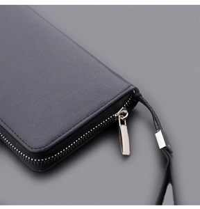 Close-up of litchi grain leather texture and silver metal zipper on men's business clutch
