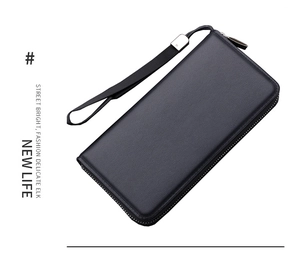 Detail view of black lychee leather men's clutch bag with metal zipper and wrist strap