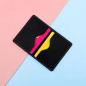 Slim black faux leather card holder with contrast stitching and dual card slots