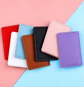 Close-up of thin faux leather card holders in various colors showing fine stitching
