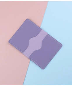 Detail of purple faux leather card holder featuring dual slots and precise white stitching
