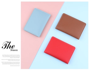 Slim leather card holders in blue, brown, and red with elegant white contrast stitching