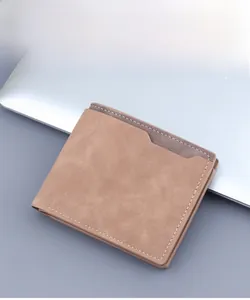 Detailed view of a brown frosted leather bi-fold wallet for men on an office desk