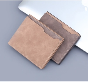 Detailed macro view of two minimalist bi-fold matte leather wallets for men with contrast stitching