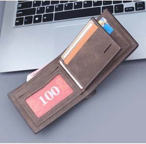 Detail view of brown bifold wallet with matte texture showing multiple card slots and ID window