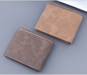 Detail view of bi-fold wallets in brown and grey with visible contrast stitching texture