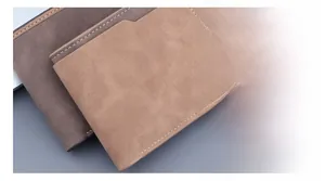 Detail of bifold wallet showing brown matte leather texture and white stitching details