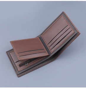 Detail of a brown leather bi-fold wallet featuring functional card slots and a zipper pocket